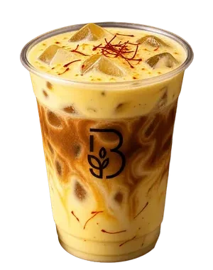 Cold foam saffron milk in a clear Beanery cup, saffron threads across the pale gold foam.